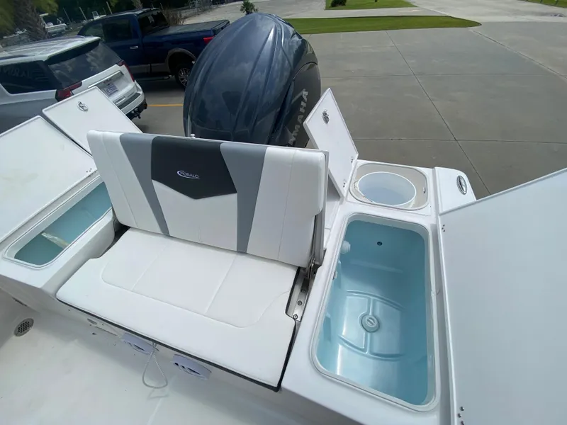 Slide: The Image of 2024 Robalo 226 Cayman boat with open storage compartments and seating. - 7