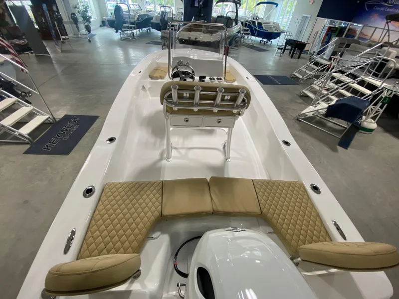 Slide: The Image of 2024 Savannah SS19 boat interior with tan seating, displayed in a showroom. - 5