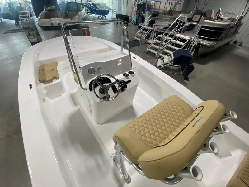 Slide: The Image of 2024 Savannah SS19 boat interior with tan quilted seats and steering console. - 7