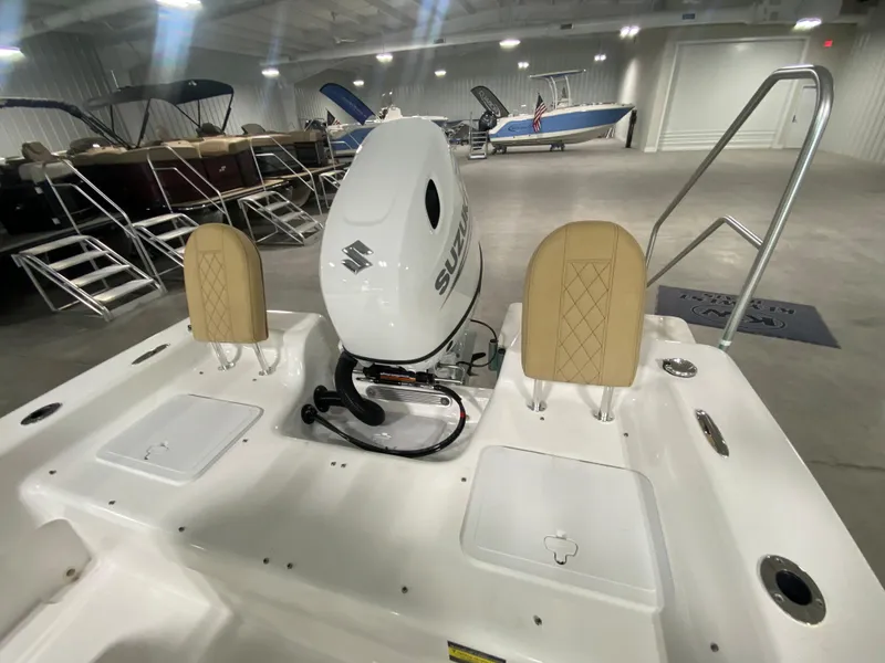 Slide: The Image of 2024 Savannah SS19 boat with Suzuki outboard motor in showroom. - 9