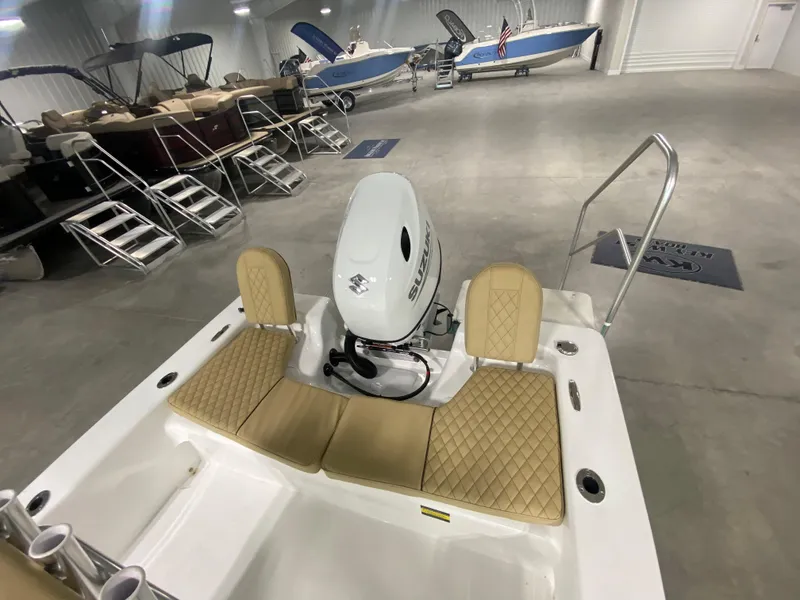 Slide: The Image of 2024 Savannah SS19 boat with Suzuki outboard motor in showroom. - 6