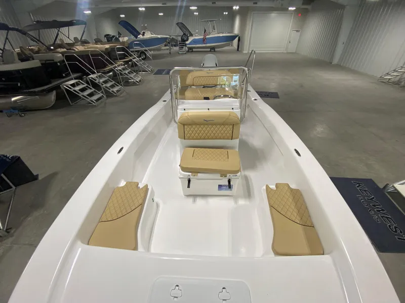 Slide: The Image of 2024 Savannah SS19 boat interior with tan seats in showroom. - 8