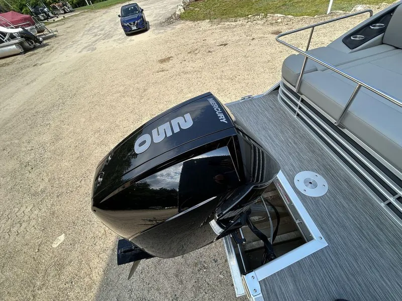 Slide: The Image of 2022 Bennington L25 boat with Mercury outboard motor on a sandy shore. - 10