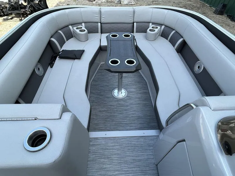 Slide: The Image of 2022 Bennington L25 boat interior with gray seating and cup holders. - 5