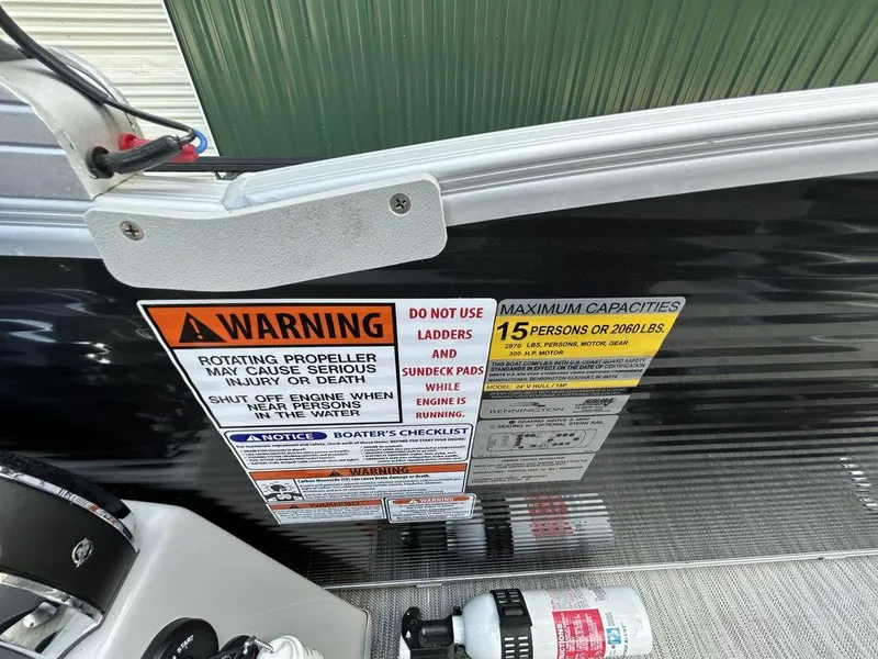 Slide: The Image of Warning and capacity labels on a 2022 Bennington L25 boat. - 8