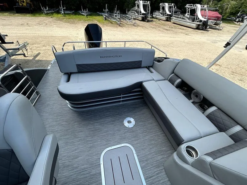 Slide: The Image of 2022 Bennington L25 boat interior with gray seating and cup holders. - 9
