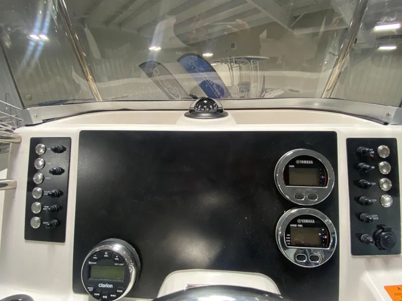 Slide: The Image of 2024 Robalo R180 Center Console dashboard with Yamaha gauges and controls. - 10