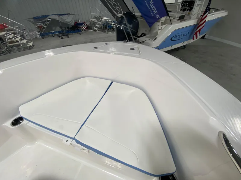 Slide: The Image of 2024 Robalo R180 Center Console boat interior with cushioned seating. - 15