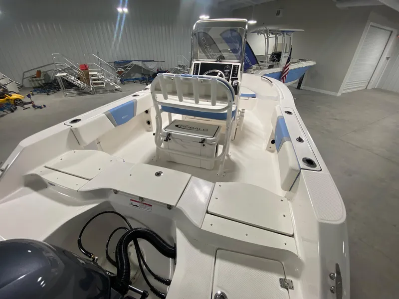 Slide: The Image of 2024 Robalo R180 Center Console boat in indoor storage facility. - 5