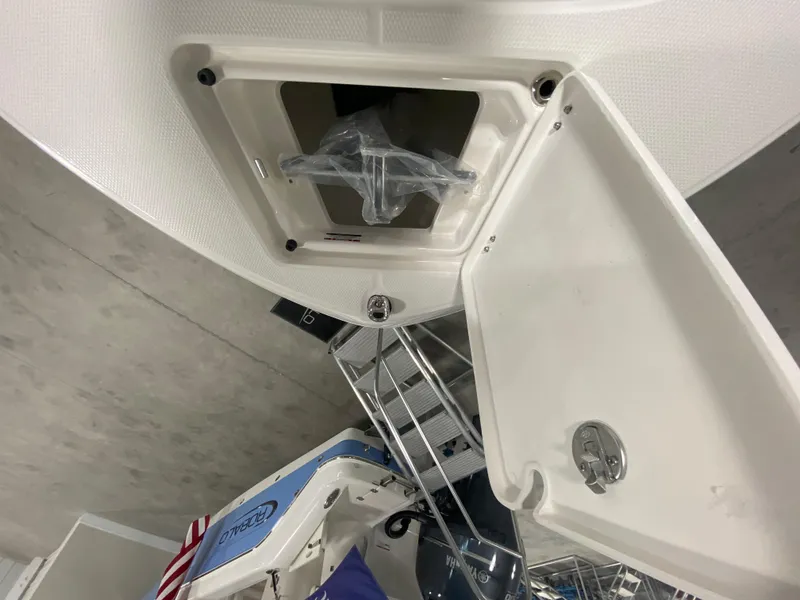 Slide: The Image of 2024 Robalo R180 Center Console storage compartment with open hatch. - 18