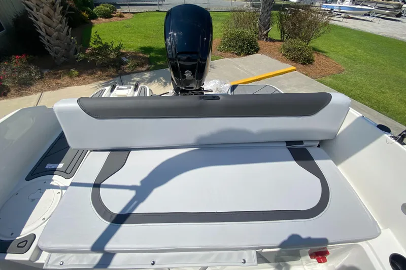 Slide: The Image of 2024 Bayliner Element M19 boat interior with cushioned seating and outboard motor. - 15