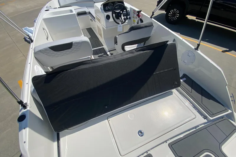 Slide: The Image of 2024 Bayliner Element M19 boat interior with seating and steering console. - 19