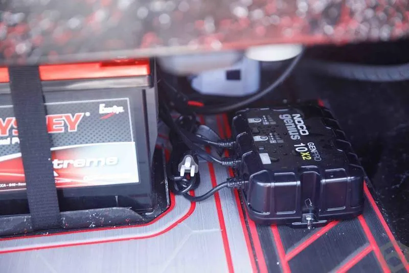 Slide: The Image of Battery and charger setup in a 2023 Go-Devil 2060 boat. - 12