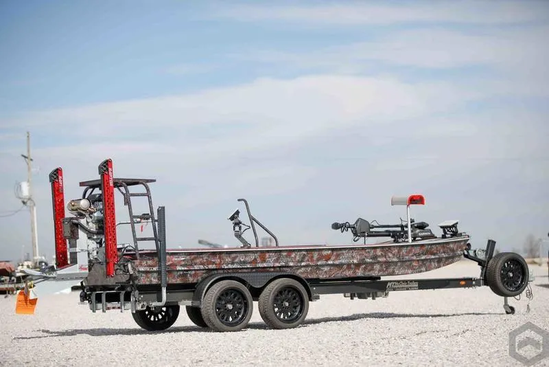 Slide: The Image of 2023 Go-Devil 2060 boat on a trailer, side view, outdoors. - 2