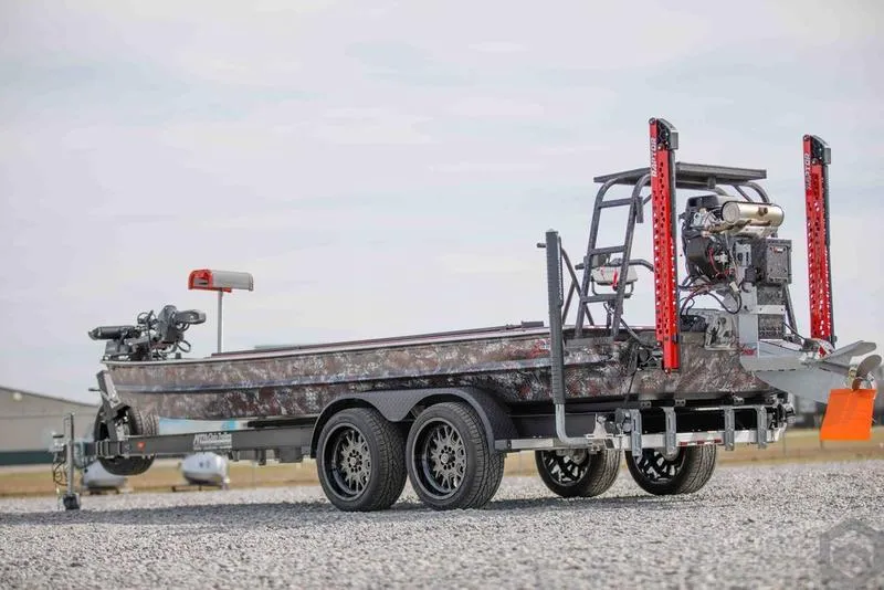 Slide: The Image of 2023 Go-Devil 2060 boat on a trailer, camo design, dual axles. - 3