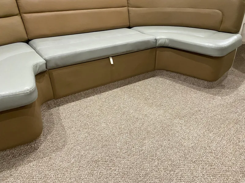 Slide: The Image of 1996 Carver 390 Express interior seating with beige and gray upholstery. - 11
