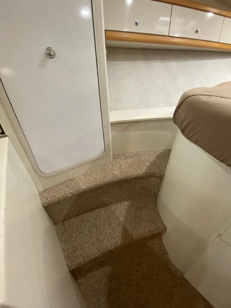 Slide: The Image of Interior of 1996 Carver 390 Express yacht with carpeted steps and storage cabinets. - 13