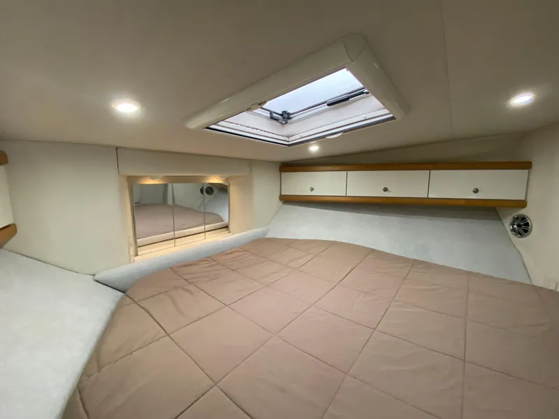 Slide: The Image of Interior cabin of 1996 Carver 390 Express with bed, skylight, and storage cabinets. - 14