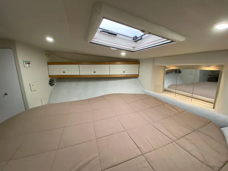 Slide: The Image of 1996 Carver 390 Express cabin interior with bed, skylight, and storage cabinets. - 15