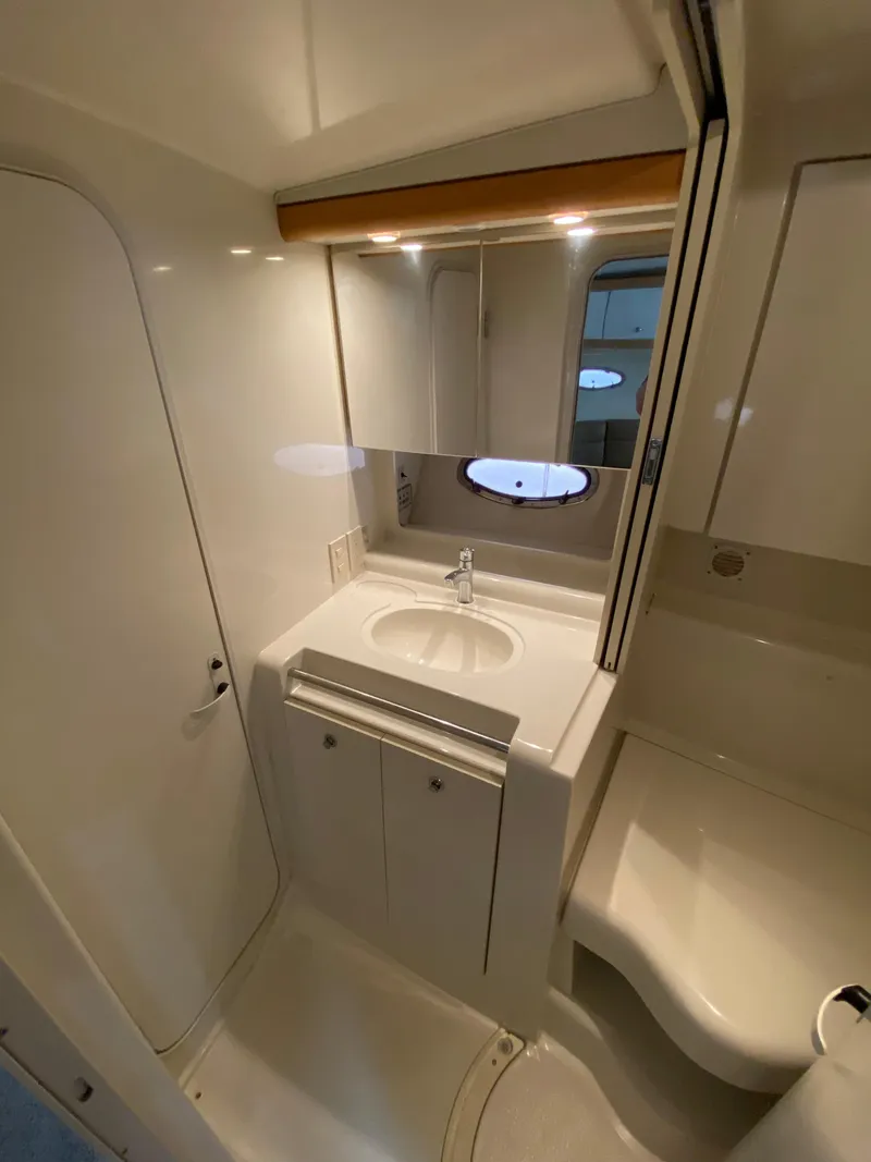 Slide: The Image of Bathroom interior of 1996 Carver 390 Express yacht, featuring sink and mirror. - 16