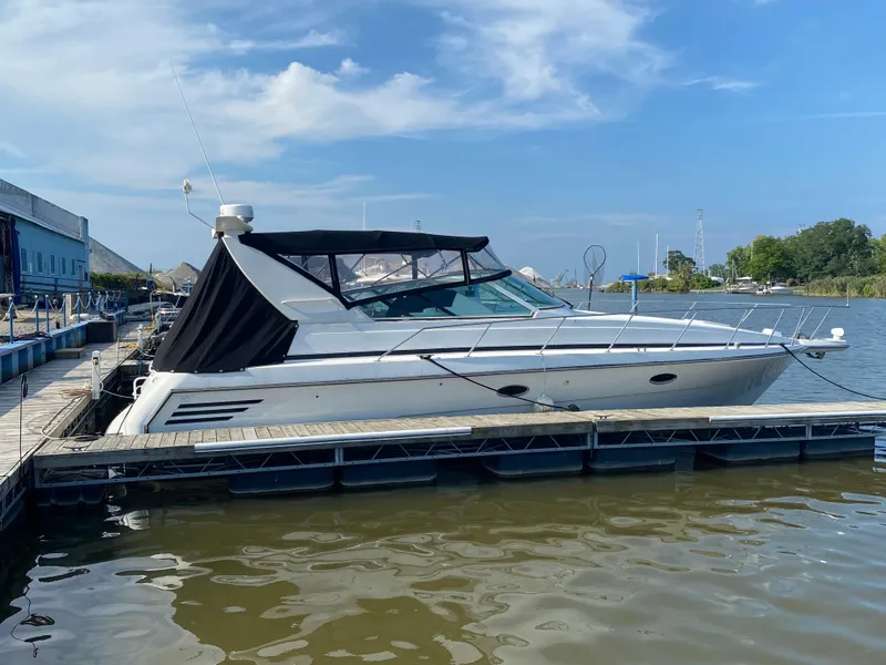Slide: The Image of 1996 Carver 390 Express yacht docked at marina under clear blue sky. - 2