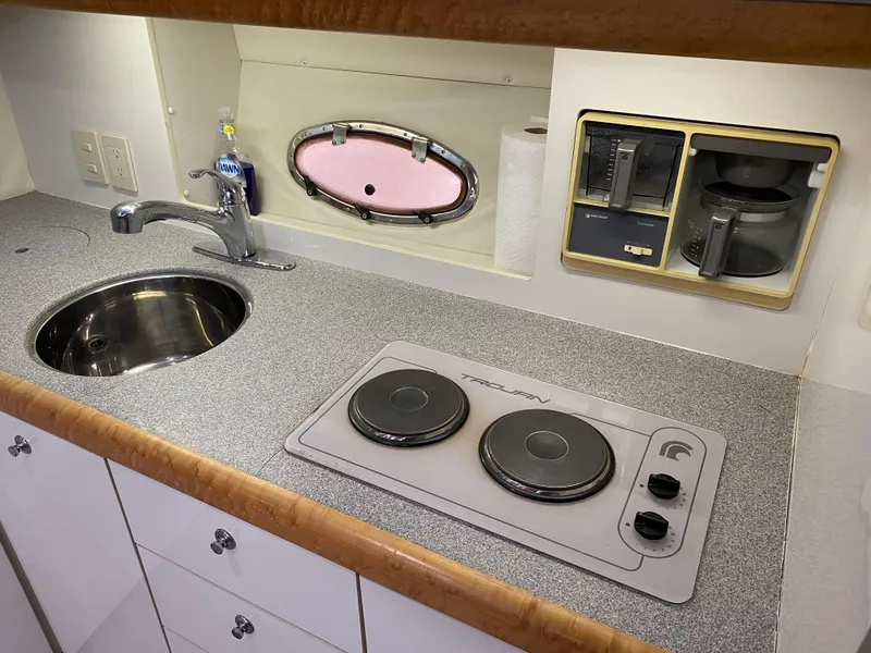 Slide: The Image of Compact kitchen in a 1996 Carver 390 Express yacht with stove, sink, and coffee maker. - 20