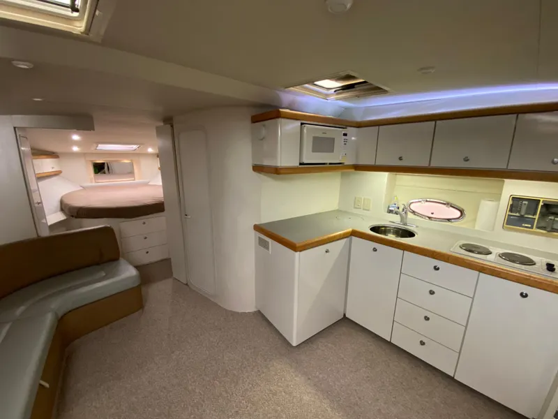 Slide: The Image of Interior of 1996 Carver 390 Express yacht with kitchen and sleeping area. - 22