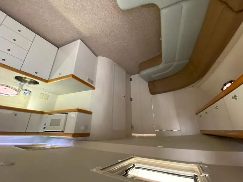 Slide: The Image of Interior of 1996 Carver 390 Express yacht with kitchenette and seating area. - 23