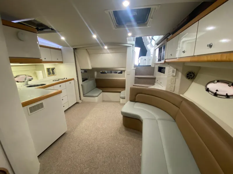 Slide: The Image of Interior of 1996 Carver 390 Express yacht with modern kitchen and seating area. - 26