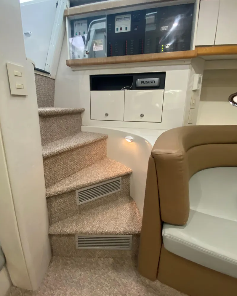 Slide: The Image of Interior of 1996 Carver 390 Express with carpeted stairs and control panel. - 27