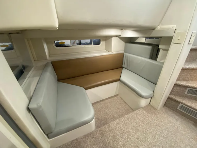 Slide: The Image of Interior seating area of 1996 Carver 390 Express yacht with beige and gray cushions. - 28