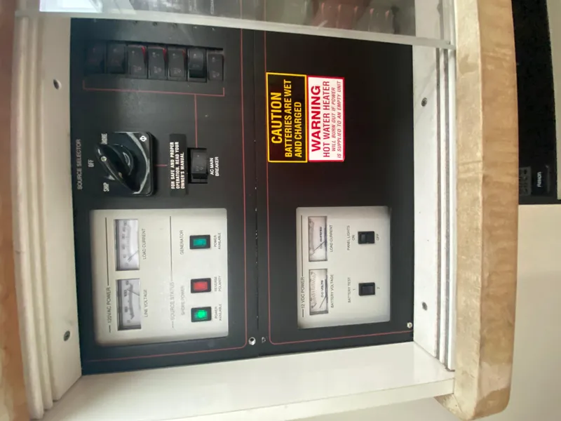 Slide: The Image of Control panel of a 1996 Carver 390 Express boat with warning labels and switches. - 31