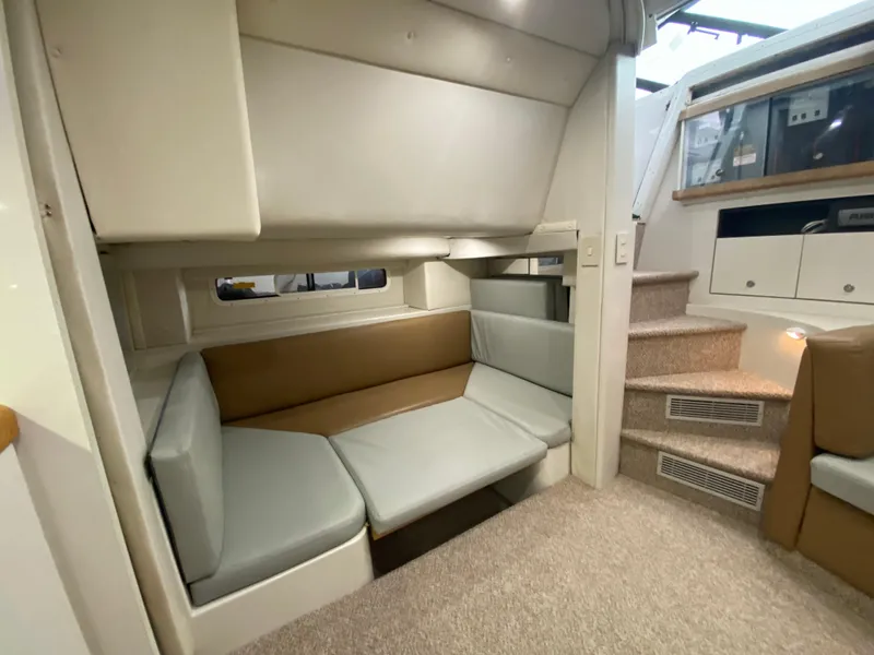 Slide: The Image of 1996 Carver 390 Express interior with cozy seating and carpeted stairs. - 36
