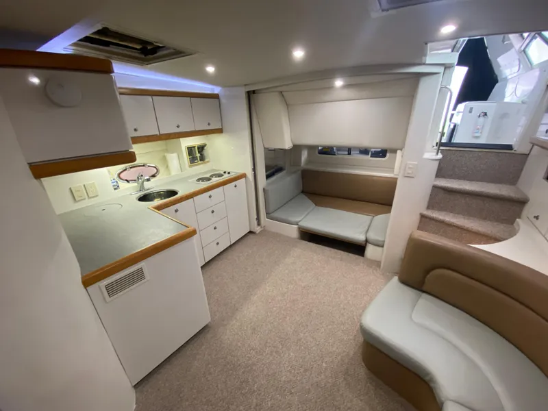 Slide: The Image of Interior of 1996 Carver 390 Express yacht with kitchen and seating area. - 37