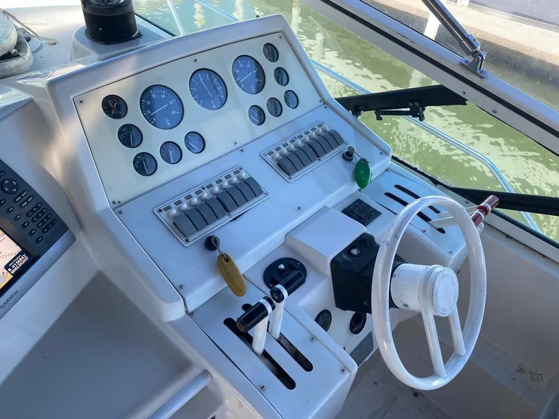 Slide: The Image of 1996 Carver 390 Express helm with gauges, controls, and steering wheel. - 5