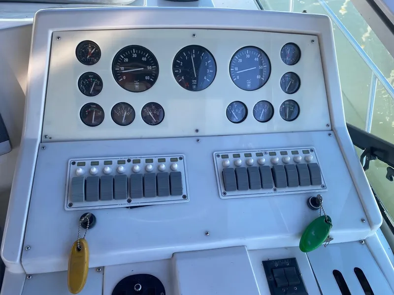 Slide: The Image of Control panel of a 1996 Carver 390 Express boat with gauges and switches. - 7
