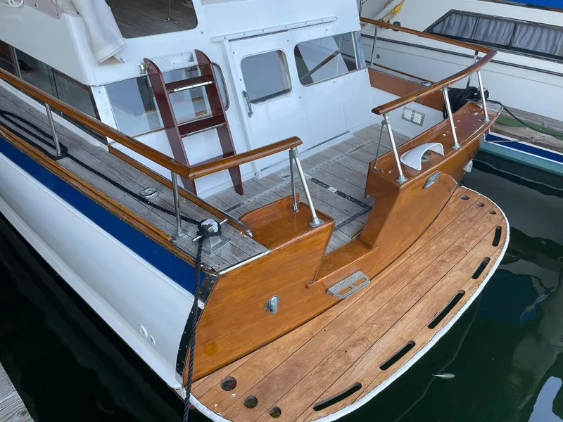 Slide: The Image of 1961 Chris-Craft Conqueror boat with wooden deck and white cabin, docked at marina. - 12