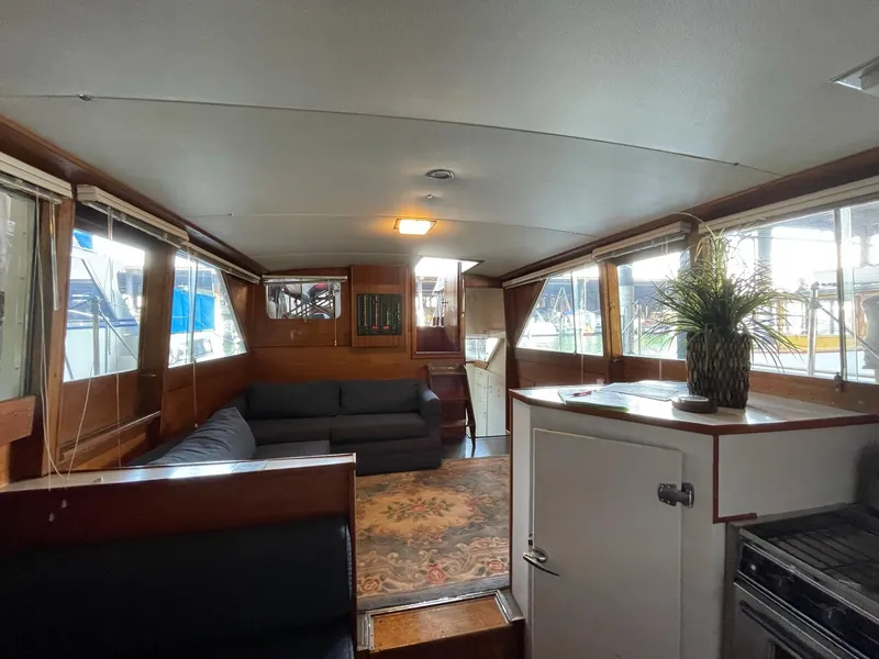 Slide: The Image of Interior of a 1961 Chris-Craft Conqueror boat with cozy seating and wooden accents. - 17