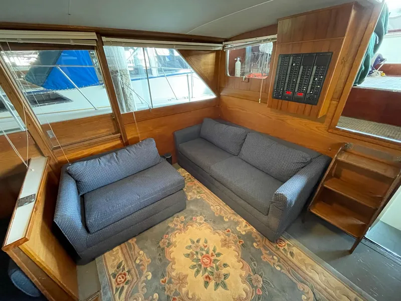 Slide: The Image of Interior of 1961 Chris-Craft Conqueror with blue sofas and floral rug. - 18