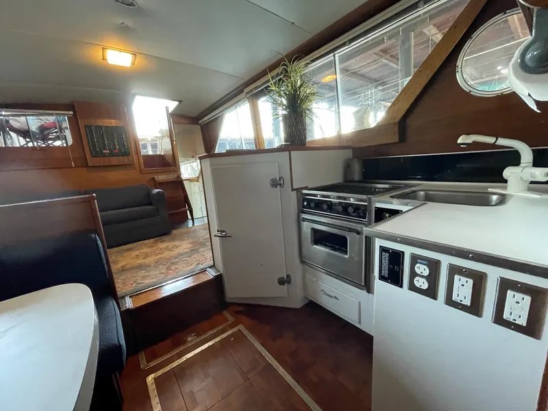Slide: The Image of 1961 Chris-Craft Conqueror interior with kitchen, seating area, and wood accents. - 22