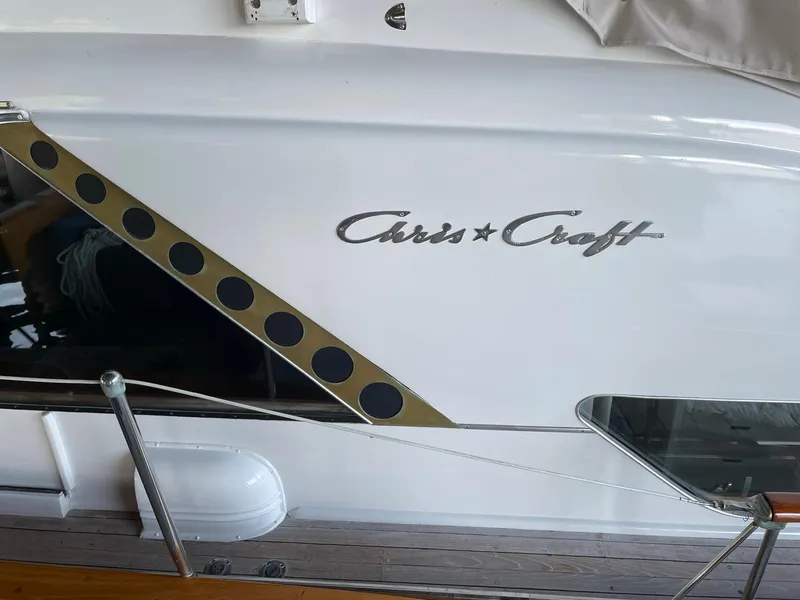 Slide: The Image of 1961 Chris-Craft Conqueror boat with distinctive logo and sleek design. - 3