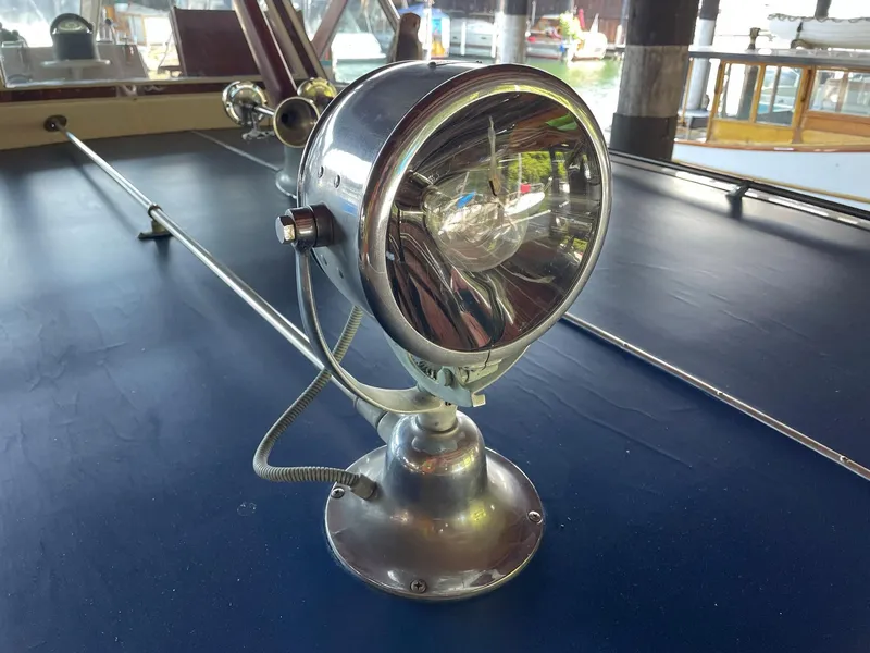 Slide: The Image of 1961 Chris-Craft Conqueror spotlight on deck, showcasing vintage nautical design. - 36