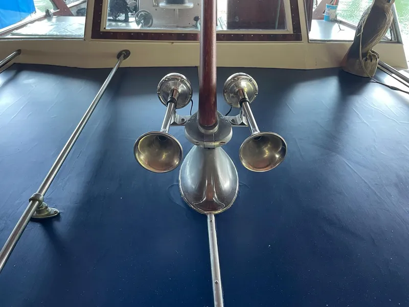 Slide: The Image of 1961 Chris-Craft Conqueror boat deck with chrome horns and blue cover. - 37