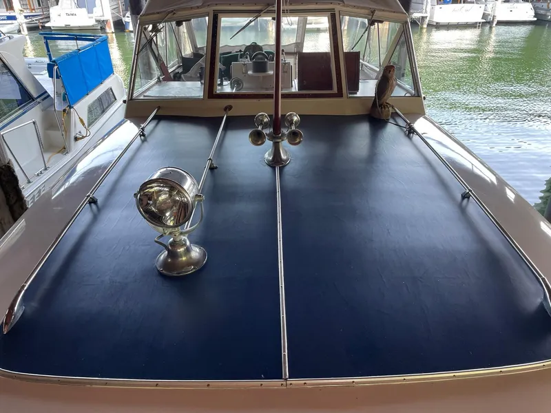 Slide: The Image of 1961 Chris-Craft Conqueror boat deck with spotlight and horn, docked in marina. - 38