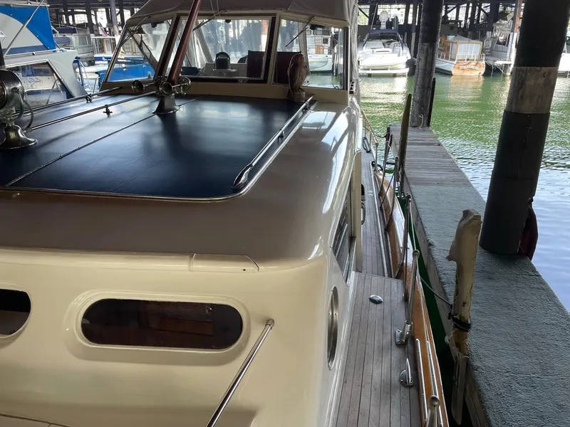 Slide: The Image of 1961 Chris-Craft Conqueror docked in a marina, showcasing classic design and craftsmanship. - 39