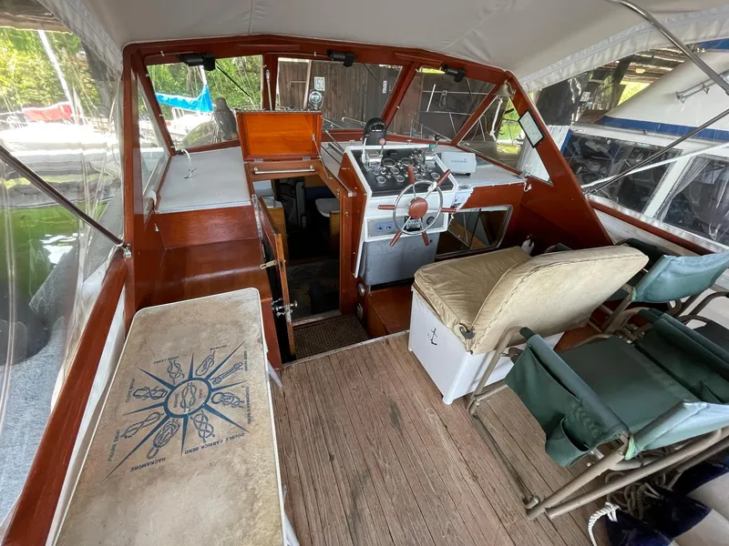 Slide: The Image of 1961 Chris-Craft Conqueror boat interior with wooden dashboard and seating area. - 4
