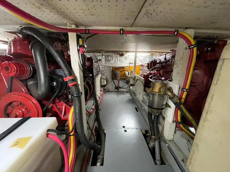 Slide: The Image of Engine room of a 1961 Chris-Craft Conqueror with visible red machinery and wiring. - 42