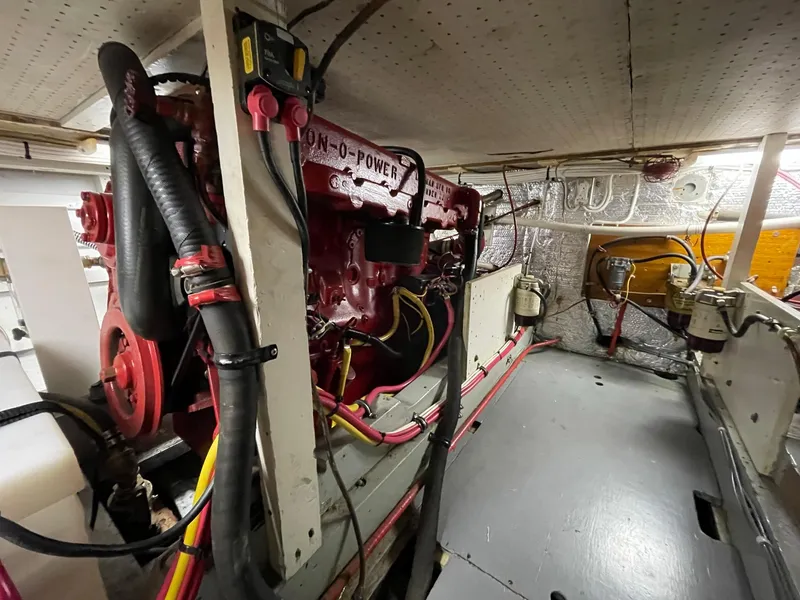 Slide: The Image of Engine room of a 1961 Chris-Craft Conqueror boat, showcasing mechanical components and wiring. - 44