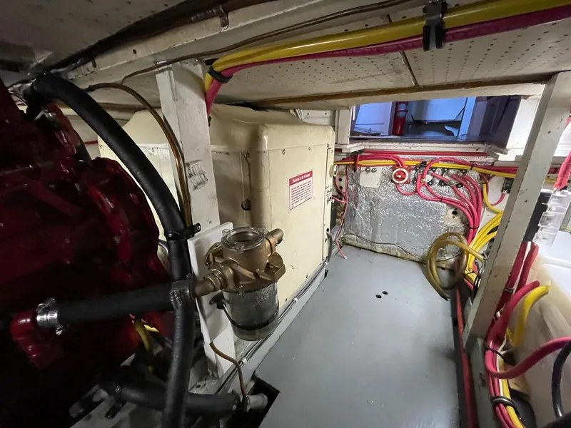 Slide: The Image of Engine room of a 1961 Chris-Craft Conqueror with visible wiring and mechanical components. - 46