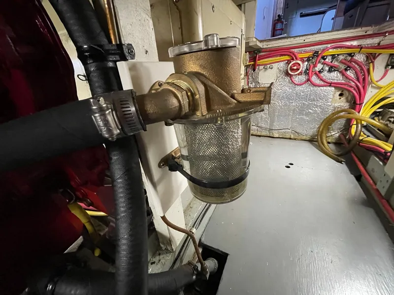Slide: The Image of 1961 Chris-Craft Conqueror engine room with brass filter and hoses. - 47